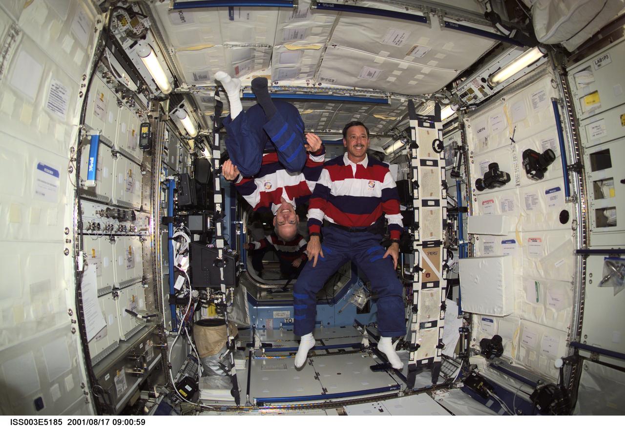 ISS003-E-5185 (17 August 2001) --- Astronauts Daniel T. Barry (left), STS-105 mission specialist, and Scott J. Horowitz, commander, pause from their daily activities to pose for this photo in the Destiny laboratory while visiting the International Space Station (ISS). This image was taken with a digital still camera.