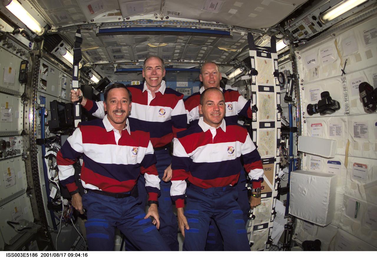 ISS003-E-5186 (17 August 2001) --- Astronauts Scott J. Horowitz (bottom left), STS-105 mission commander, Frederick W. (Rick) Sturckow, pilot, Daniel T. Barry (top left), and Patrick G. Forrester, both mission specialists, pause from their daily activities to pose for this photo in the Destiny laboratory while visiting the International Space Station (ISS). This image was taken with a digital still camera.