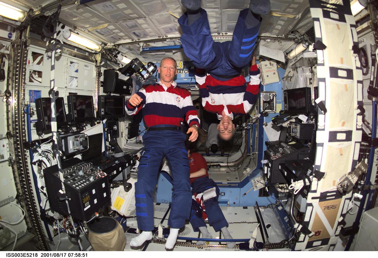 ISS003-E-5218 (17 August 2001) --- Astronauts Patrick G. Forrester (left) and Daniel T. Barry, both STS-105 mission specialists, pause from their daily activities to pose for this photo taken in the Destiny laboratory on the International Space Station (ISS). This image was taken with a digital still camera.