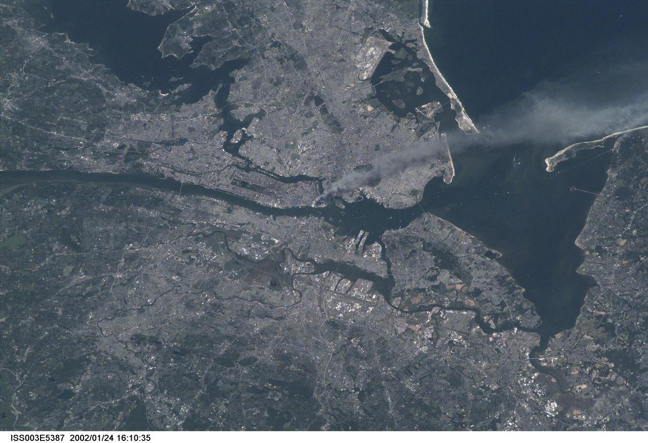 ISS003-E-5387 (11 September 2001) --- One of a series of pictures taken of metropolitan New York City (and other parts of New York as well as New Jersey) by one of the Expedition Three crew members onboard the International Space Station (ISS) at various times during the day of September 11, 2001.   The image shows a smoke plume rising from the Manhattan area. The orbital outpost was flying at an altitude of approximately 250 miles.  The image was recorded with a digital still camera. Please note:  The date identifiers on some frames (other than those that indicate Sept. 11, 2001) are not accurate due to a technical problem with one of the Expedition Three cameras.