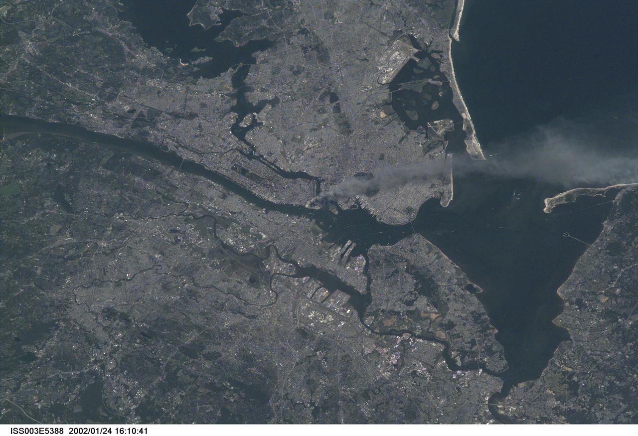 ISS003-E-5388 (11 September 2001) --- One of a series of pictures taken of metropolitan New York City (and other parts of New York as well as New Jersey) by one of the Expedition Three crew members onboard the International Space Station (ISS) at various times during the day of September 11, 2001.   The image shows a smoke plume rising from the Manhattan area. The orbital outpost was flying at an altitude of approximately 250 miles.  The image was recorded with a digital still camera. Please note:  The date identifiers on some frames (other than those that indicate Sept. 11, 2001) are not accurate due to a technical problem with one of the Expedition Three cameras.