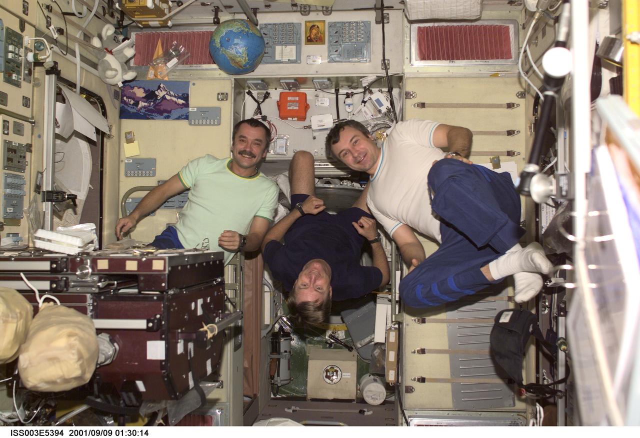 ISS003-E-5394 (9 September 2001) --- The Expedition Three crewmembers assemble for a crew photo in the Zvezda  Service Module (SM) of the International Space Station (ISS).   Astronaut Frank L. Culbertson, Jr. (center) is the Expedition Three commander.  He is flanked by cosmonauts Mikhail Tyurin (left) and Vladimir Dezhurov,  both flight engineers representing Rosaviakosmos.  This picture was taken with a digital still camera.