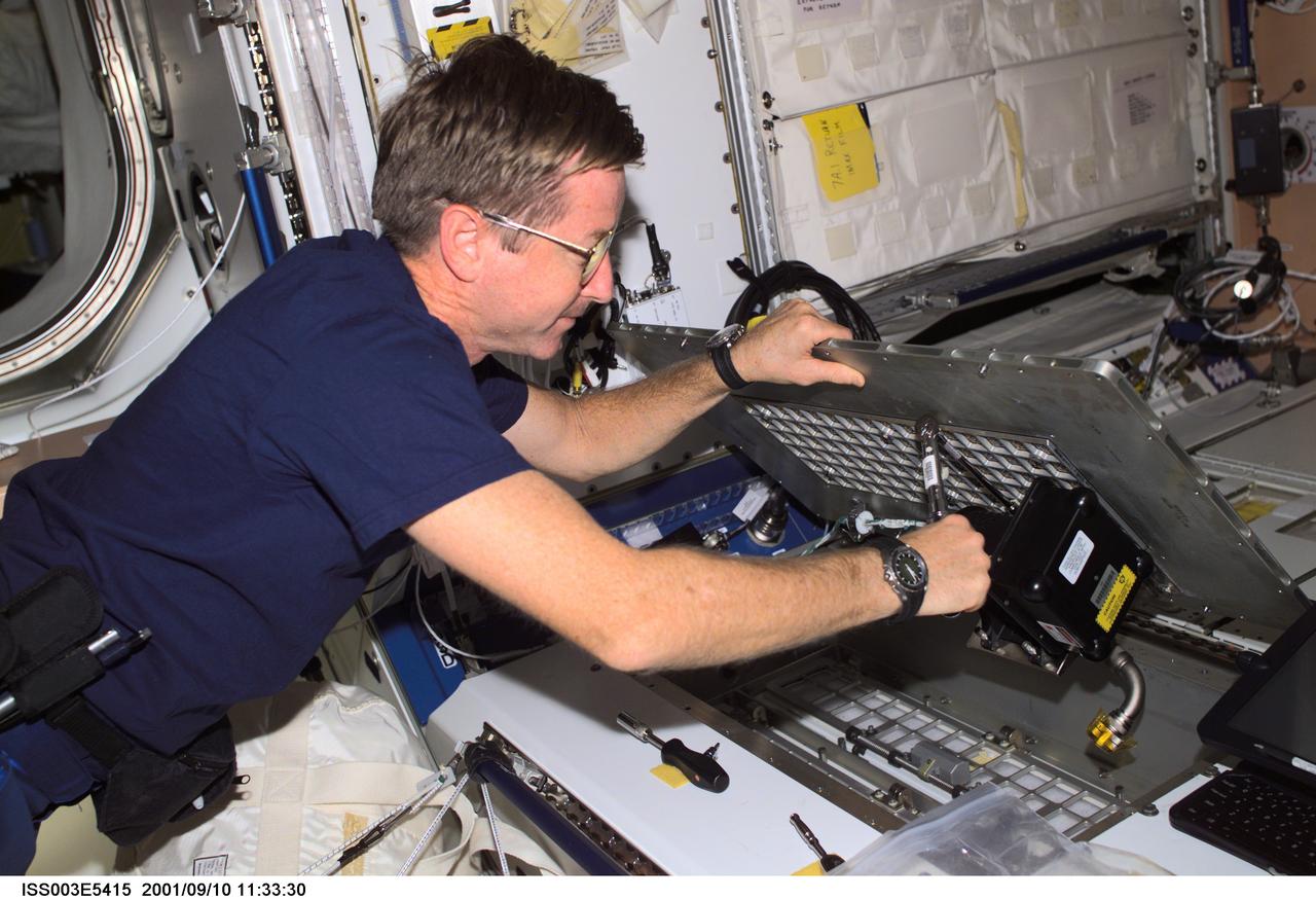 ISS003-E-5415 (10 September 2001) --- Expedition Three mission commander Frank L. Culbertson, Jr., conducts inflight maintenance with a ratchet under a panel in the Unity Node 1 on the International Space Station (ISS).  This image was taken with a digital still camera.
