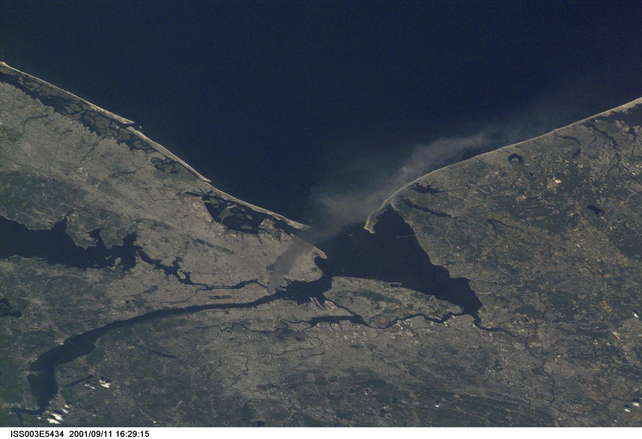 ISS003-E-5434 (11 September 2001) --- One of a series of pictures taken of metropolitan New York City (and other parts of New York as well as New Jersey) by one of the Expedition Three crew members onboard the International Space Station (ISS) at various times during the day of September 11, 2001. The image shows a smoke plume rising from the Manhattan area. The orbital outpost was flying at an altitude of approximately 250 miles. The image was recorded with a digital still camera. Please note: The date identifiers on some frames (other than those that indicate Sept. 11, 2001) are not accurate due to a technical problem with one of the Expedition Three cameras.