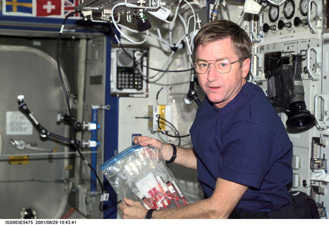 ISS003-E-5475 (29 August 2001) --- Astronaut Frank L. Culbertson, Expedition Three mission commander, holds a syringe kit to be used in the Quad Tissue Culture Module Assemblies (QTCMA) for the Biotechnology Specimen Temperature Controller (BSTC) experiment in the U.S. Laboratory.