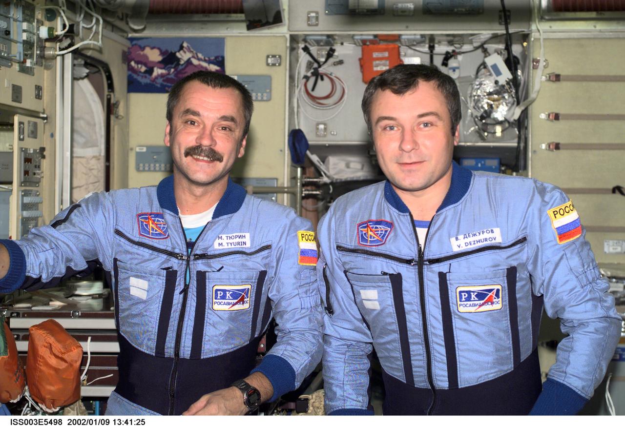 ISS003-E-5498 (August 2001) --- Cosmonauts Mikhail Tyurin (left) and Vladimir Dezhurov, Expedition Three flight engineers, pose for a photograph in the Zvezda Service Module.  Tyurin and Dezhurov represent Rosaviakosmos.  Please note:  The date identifiers on some frames are not accurate due to a technical problem with one of the Expedition Three cameras. When a specific date is given in the text or description portion, it is correct.