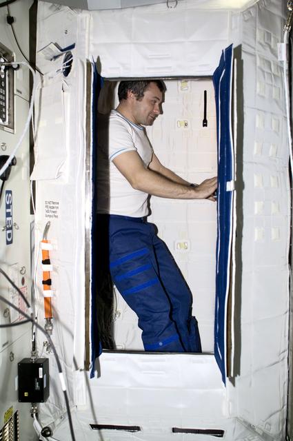 NASA image: Dezhurov works in the sleep station in the U.S. Laboratory during Expedition Three