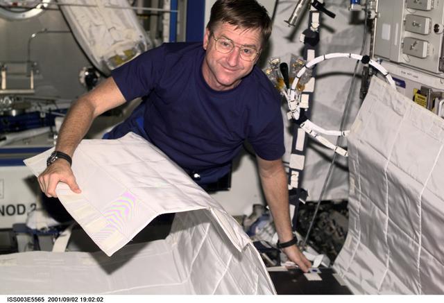 NASA image: Culbertson sets up the Temporary Sleep Station (TESS) in Destiny during Expedition Three