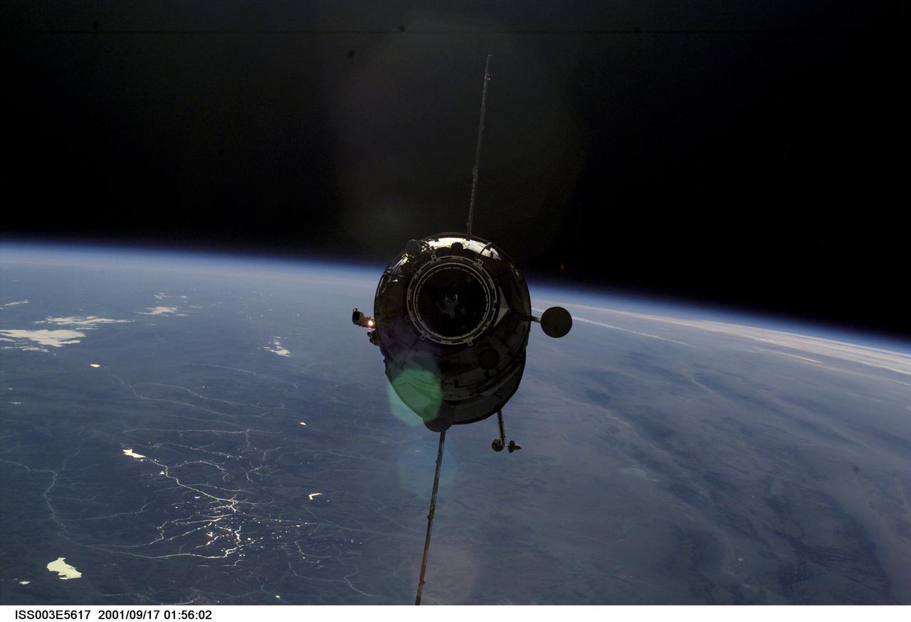 ISS003-E-5617 (16 September 2001) --- Appearing almost as a silhouette backdropped against Earth's horizon, the Russian Docking Compartment, named Pirs (the Russian word for pier), approaches the International Space Station (ISS).  One of the Expedition Three crew members, using a digital still camera with a 70mm lens, recorded the image from onboard the orbital outpost. The vehicle was launched on September 14, 2001 and docking occurred on September 16.