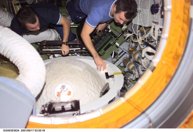 NASA image: Dezhurov and Tyurin remove the docking probe in Zvezda during Expedition Three