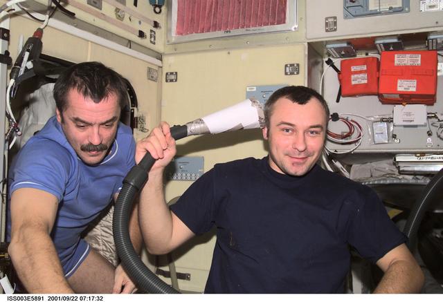 NASA image: Tyurin gives Dezhurov a haircut in the Service Module during Expedition Three