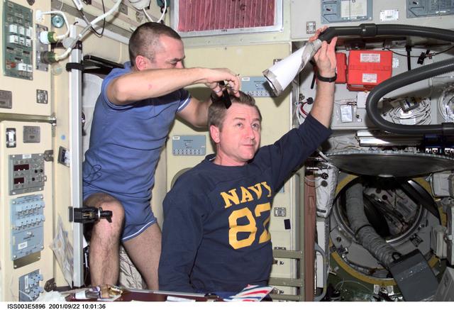 NASA image: Tyurin gives Culbertson a haircut in the Service Module during Expedition Three
