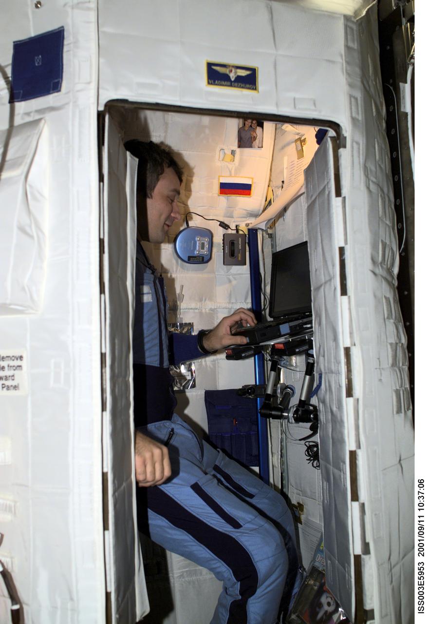 ISS003-E-5953 (11 September 2001) --- Cosmonaut Vladimir N. Dezhurov, Expedition Three flight engineer, works on a laptop computer in the Temporary Sleep Station (TSS) in the Destiny laboratory on the International Space Station (ISS).  Dezhurov represents Rosaviakosmos. This image was taken with a digital still camera.