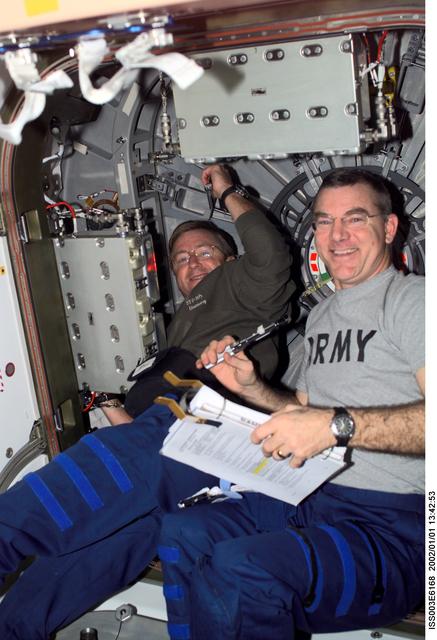 NASA image: Culbertson and Voss work at a Node 1 hatch during Expedition Three