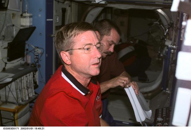 NASA image: Culbertson and Tyurin work at the SSRMS controls in Destiny during Expedition Three