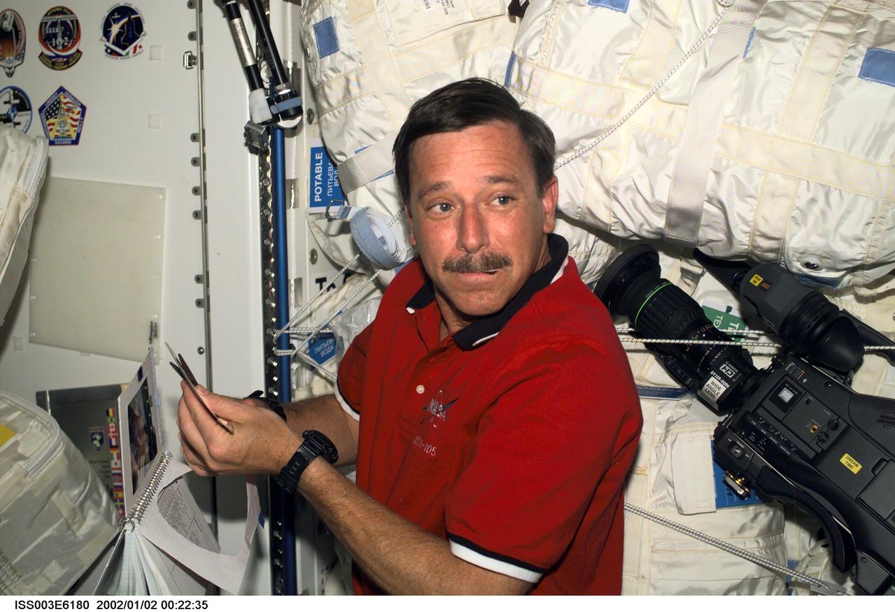 ISS003-E-6180 (August 2001) --- Astronaut Scott J. Horowitz, STS-105 mission commander, prepares the STS-105 crew patch to be added to the growing collection of those representing Shuttle crews who have worked on the International Space Station (ISS). Horowitz is located in the Unity node of the ISS. This image was taken with a digital still camera.