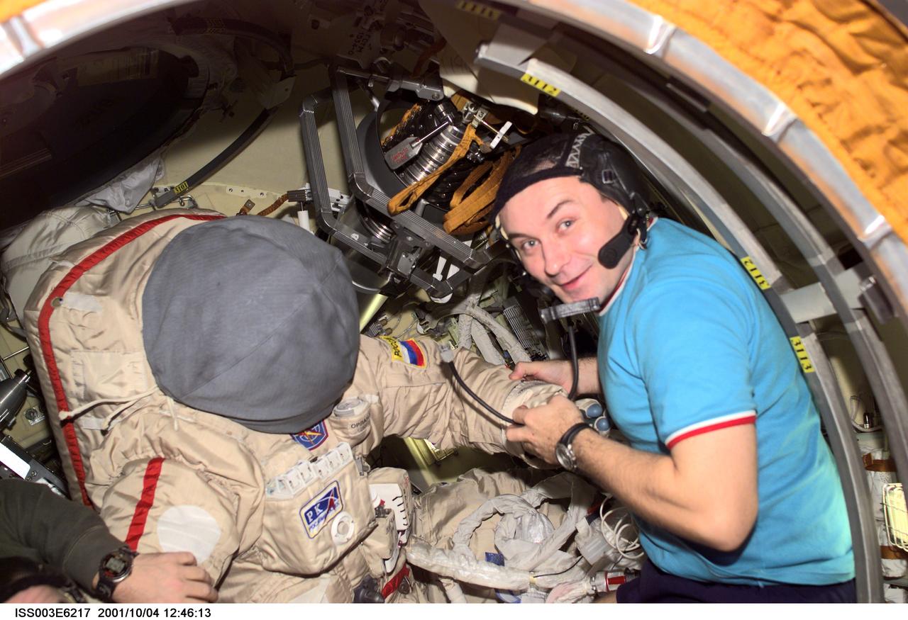 ISS003-E-6217 (4 October 2001) --- Cosmonaut Vladimir N. Dezhurov, Expedition Three flight engineer, prepares the Russian Orlan space suit for an upcoming spacewalk from the Pirs Docking Compartment on the International Space Station (ISS). Dezhurov represents Rosaviakosmos. This image was taken with a digital still camera.