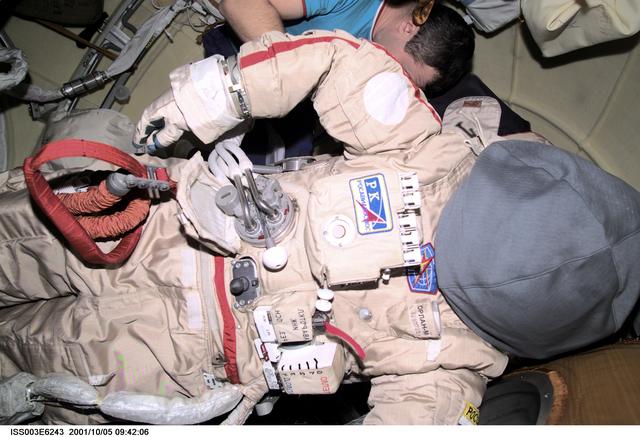 NASA image: Dezhurov works on an Orlan suit in Pirs during Expedition Three