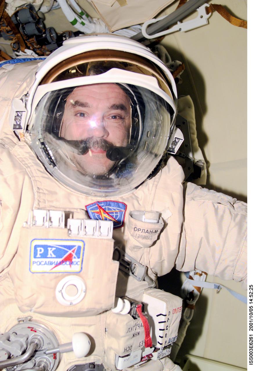 ISS003-E-6261 (5 October 2001) --- Cosmonaut Mikhail Tyurin, Expedition Three flight engineer, wears the Russian Orlan space suit as he prepares for an upcoming spacewalk from the Pirs Docking Compartment on the International Space Station (ISS).  The first spacewalk is scheduled for October 8, 2001 which will be the first extravehicular activity (EVA) from the station without a Space Shuttle present. Tyurin represents Rosaviakosmos. This image was taken with a digital still camera.