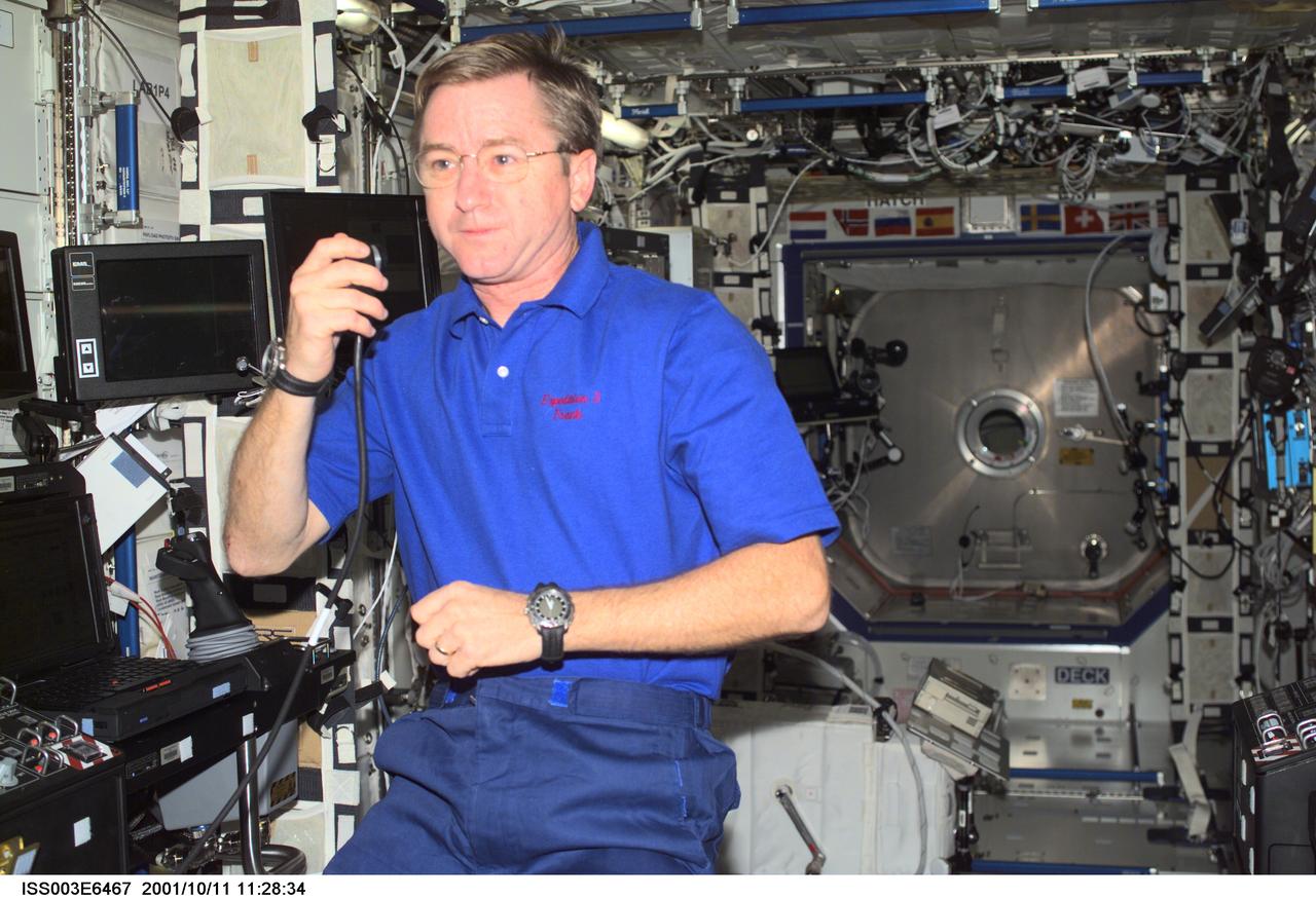 ISS003-E-6467 (11 October 2001) --- Astronaut Frank L. Culbertson, Jr., Expedition Three mission commander, talks on a microphone in the Destiny laboratory on the International Space Station (ISS). This image was taken with a digital still camera.