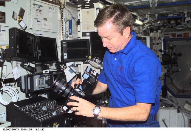 NASA image: Culbertson works on a camera in the U.S. Laboratory during Expedition Three