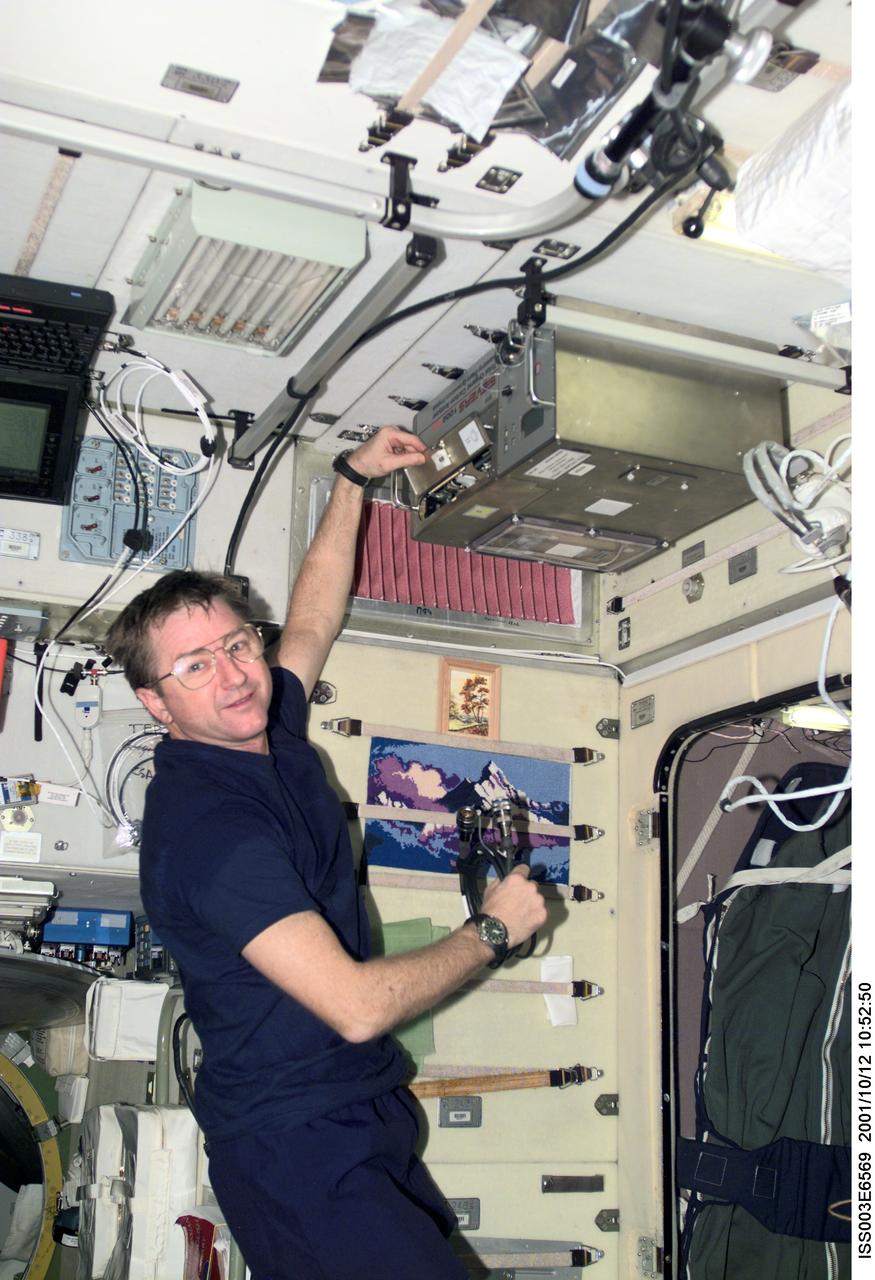 ISS003-E-6569 (12 October 2001) --- Astronaut Frank L. Culbertson, Jr., Expedition Three mission commander, works with the Total Organic Carbon Analyzer (TOCA) in the Zvezda Service Module on the International Space Station (ISS). This image was taken with a digital still camera.