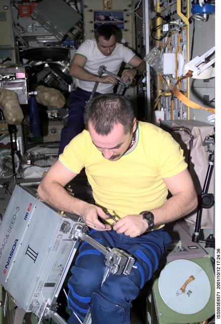 NASA image: Tyurin and Dezhurov assemble NASDA exposure experiment cases during Expedition Three