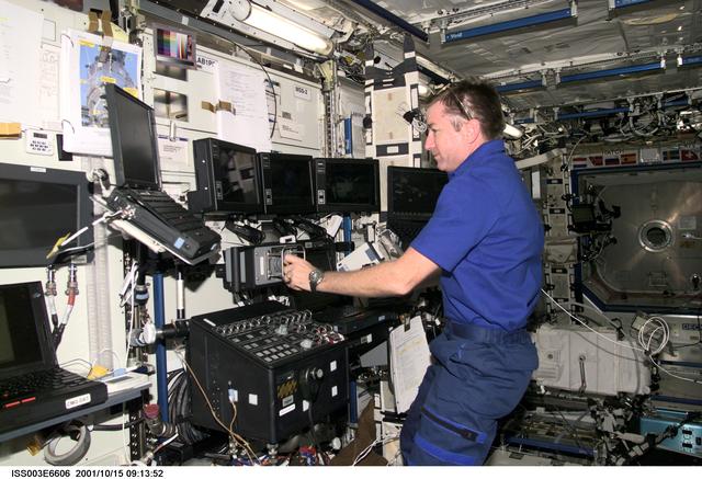 NASA image: Culbertson works at the SSRMS controls in Destiny during Expedition Three's second EVA