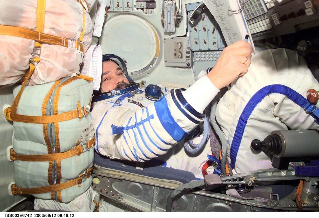 ISS003-E-6742 (October 2001) --- Cosmonaut Mikhail Tyurin, Expedition Three flight engineer, wearing a Russian Sokol suit, is seated in the Soyuz spacecraft that is docked to the International Space Station (ISS). This Soyuz return vehicle will be moved from the Earth-facing port of the Zarya module for the linkup to the new Pirs Docking Compartment. The move of the Soyuz will mark the first time the new Pirs, which arrived at the station September 17, 2001, will serve as a docking port. The Soyuz will be shifted to prepare for the arrival of a new Soyuz return craft, to be launched October 21, 2001 from the Baikonur Cosmodrome in Kazakhstan. The Soyuz can serve as a crew return vehicle at the station for a maximum of about six months. Tyurin represents Rosaviakosmos. This image was taken with a digital still camera.