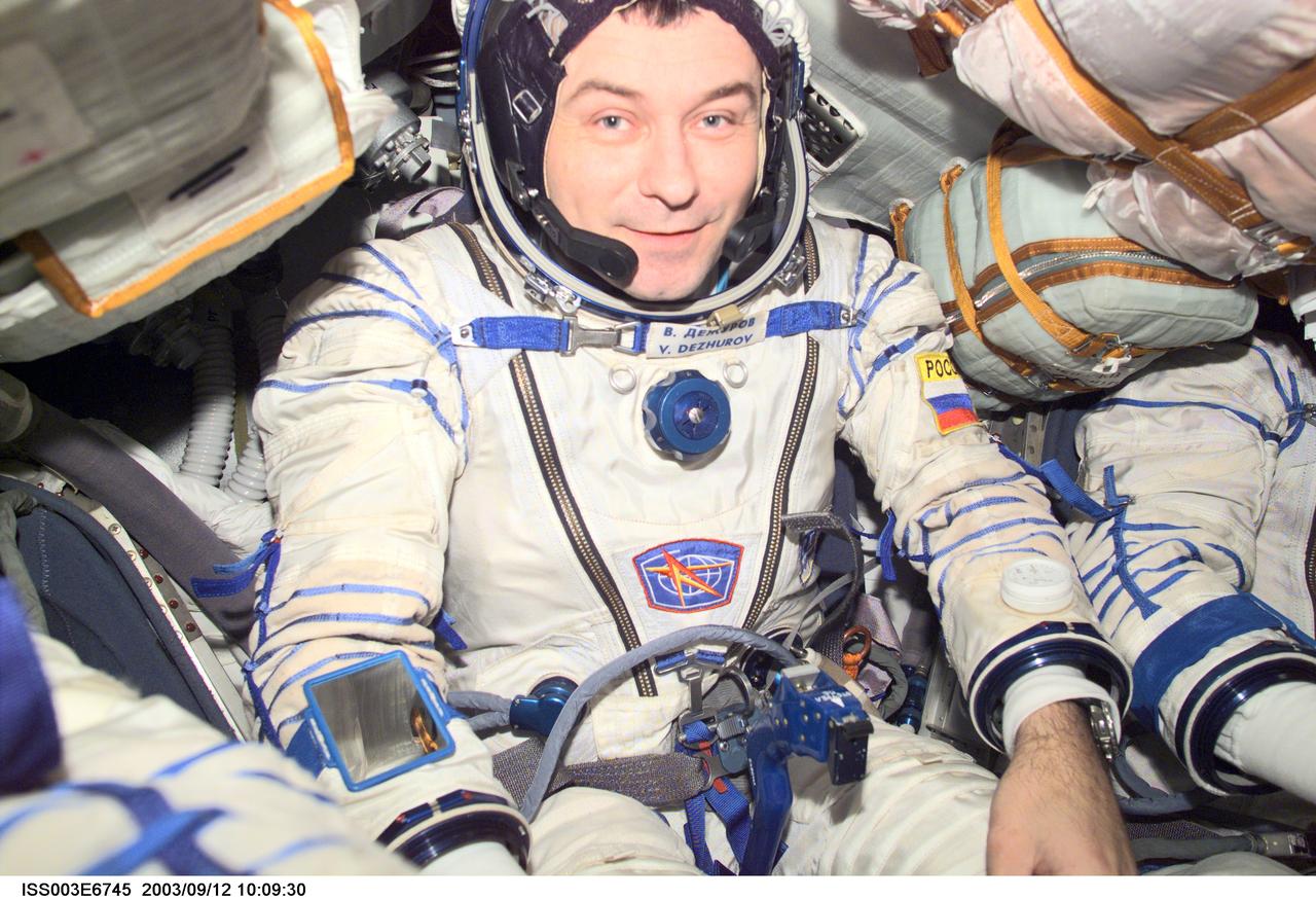 ISS003-E-6745 (October 2001) --- Cosmonaut Vladimir N. Dezhurov, Expedition Three flight engineer, wearing a Russian Sokol suit, is seated in the Soyuz spacecraft that is docked to the International Space Station (ISS). This Soyuz return vehicle will be moved from the Earth-facing port of the Zarya module for the linkup to the new Pirs Docking Compartment. The move of the Soyuz will mark the first time the new Pirs, which arrived at the station September 17, 2001, will serve as a docking port. The Soyuz will be shifted to prepare for the arrival of a new Soyuz return craft, to be launched October 21, 2001 from the Baikonur Cosmodrome in Kazakhstan. The Soyuz can serve as a crew return vehicle at the station for a maximum of about six months. Dezhurov represents Rosaviakosmos. This image was taken with a digital still camera.