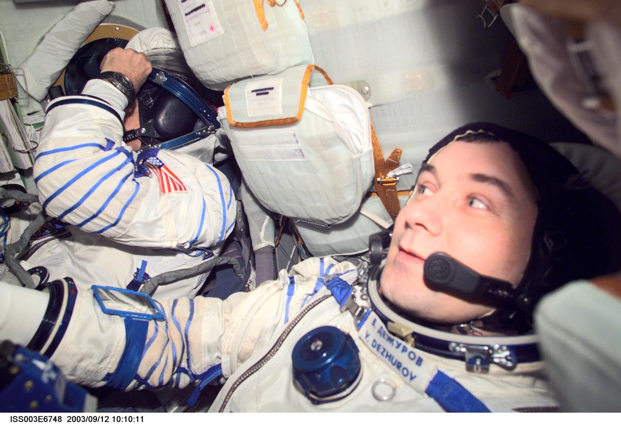 ISS003-E-6748 (October 2001) --- Astronaut Frank L. Culbertson (left), Expedition Three mission commander, and cosmonaut Vladimir N. Dezhurov, flight engineer, wearing Russian Sokol suits, are seated in the Soyuz spacecraft that is docked to the International Space Station (ISS). This Soyuz return vehicle will be moved from the Earth-facing port of the Zarya module for the linkup to the new Pirs Docking Compartment. The move of the Soyuz will mark the first time the new Pirs, which arrived at the station September 17, 2001, will serve as a docking port. The Soyuz will be shifted to prepare for the arrival of a new Soyuz return craft, to be launched October 21, 2001 from the Baikonur Cosmodrome in Kazakhstan. The Soyuz can serve as a crew return vehicle at the station for a maximum of about six months. Dezhurov represents Rosaviakosmos. This image was taken with a digital still camera.