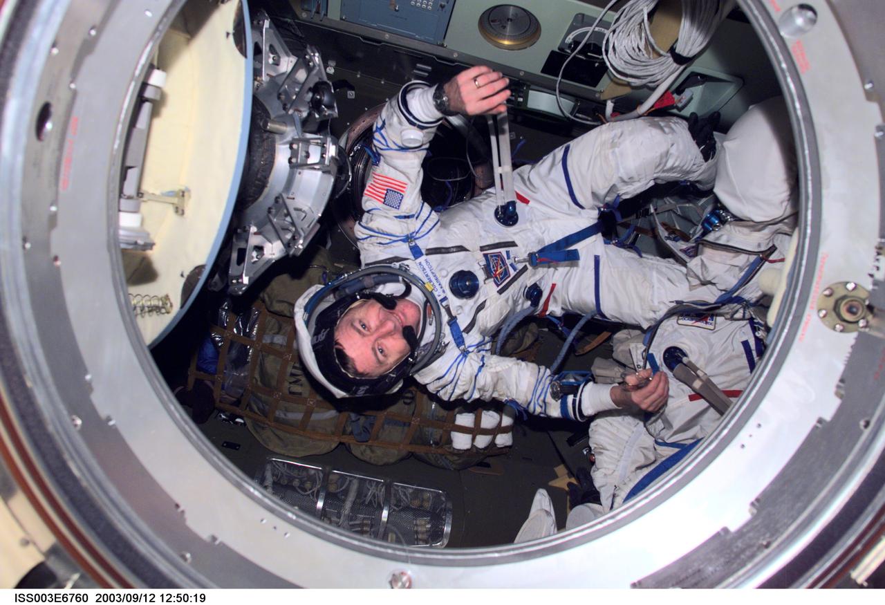ISS003-E-6760 (October 2001) --- Astronaut Frank L. Culbertson, Expedition Three mission commander, wearing a Russian Sokol suit, is photographed in the Soyuz spacecraft that is docked to the International Space Station (ISS). This Soyuz return vehicle will be moved from the Earth-facing port of the Zarya module for the linkup to the new Pirs Docking Compartment. The move of the Soyuz will mark the first time the new Pirs, which arrived at the station September 17, 2001, will serve as a docking port. The Soyuz will be shifted to prepare for the arrival of a new Soyuz return craft, to be launched October 21, 2001 from the Baikonur Cosmodrome in Kazakhstan. The Soyuz can serve as a crew return vehicle at the station for a maximum of about six months. This image was taken with a digital still camera.
