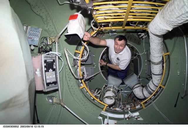 NASA image: Dezhurov moves through the FGB's Pressurized Adapter during Expedition Three