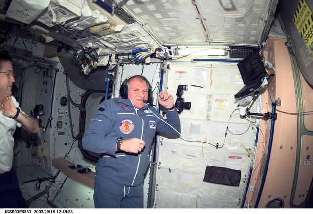 Afanasyev uses communication equipment in Node 1 during Expedition Three