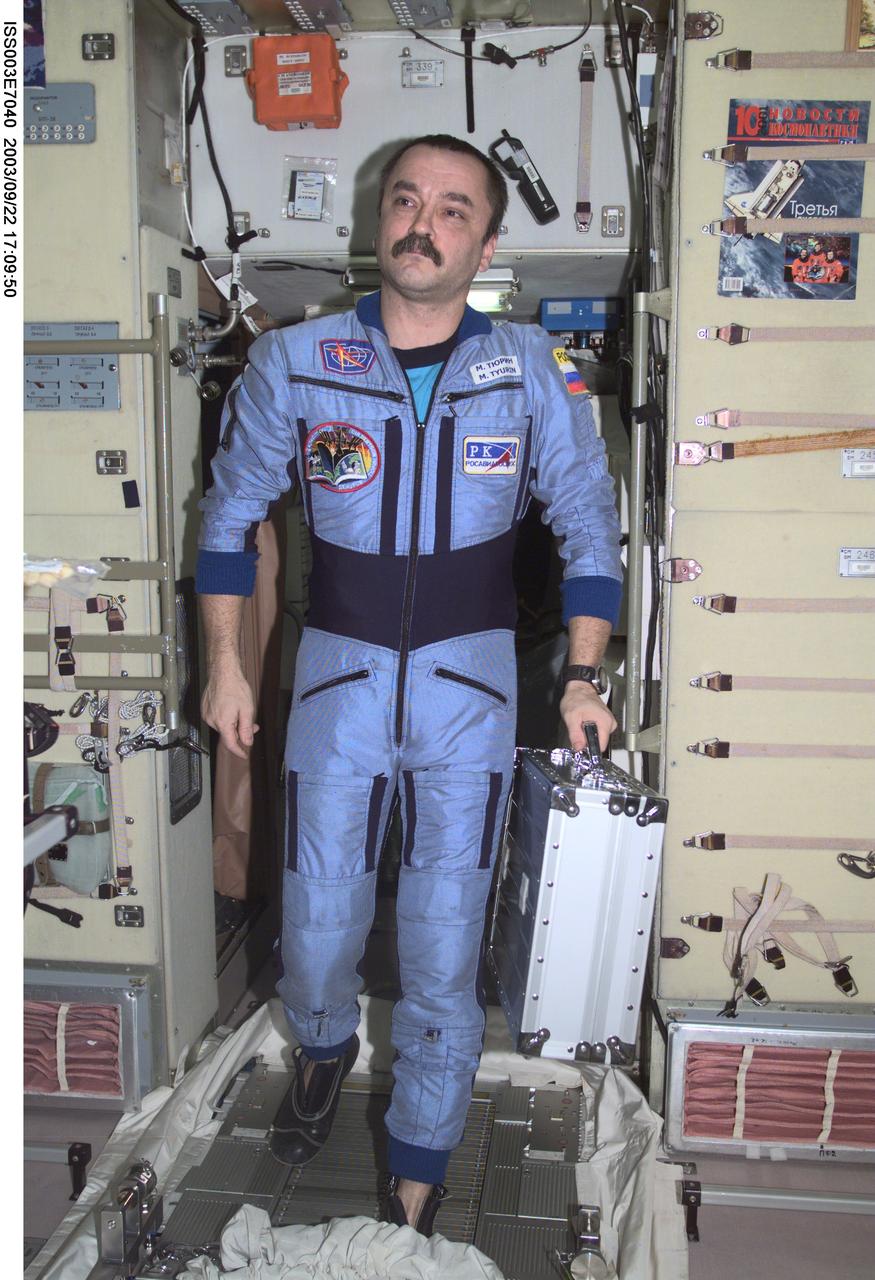 ISS003-E-7040 (October 2001) --- Cosmonaut Mikhail Tyurin, Expedition Three flight engineer representing Rosaviakosmos, moves through the Zvezda Service Module on the International Space Station (ISS).  This image was taken with a digital still camera.