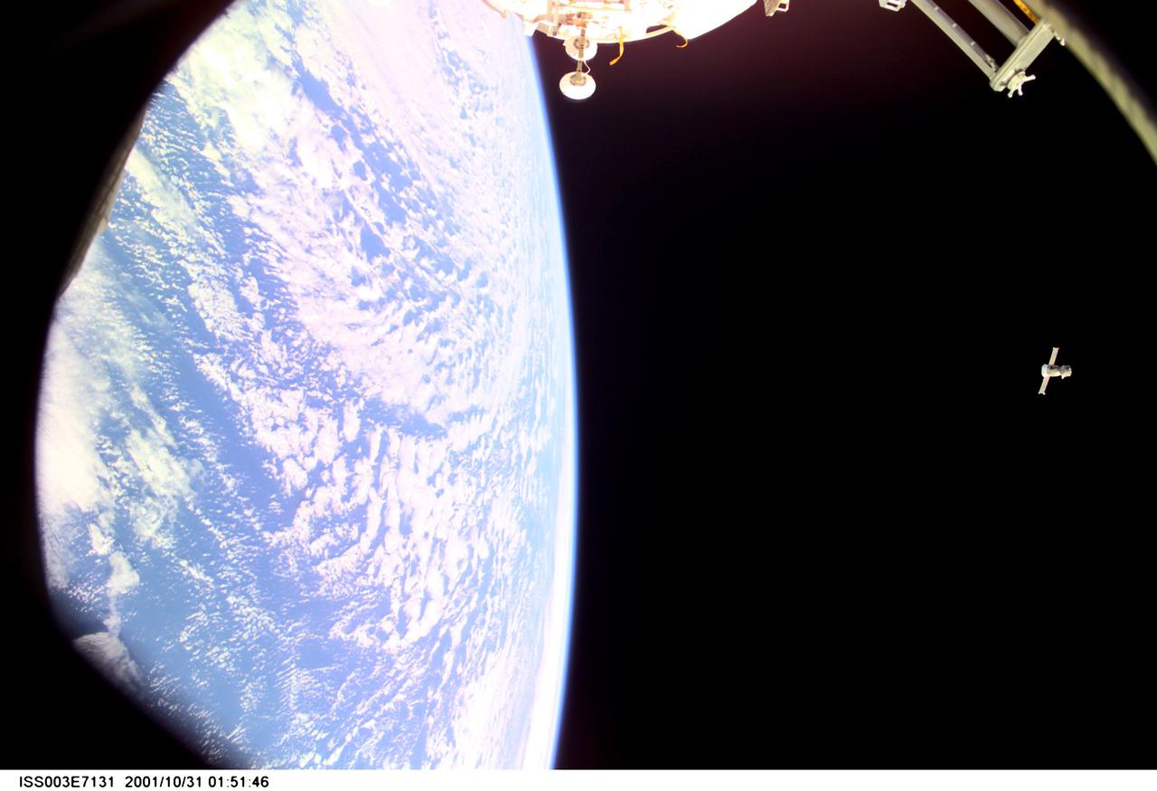 ISS003-E-7131 (31 October 2001) --- Backdropped by Earth’s horizon and the blackness of space, this distant view shows a Soyuz spacecraft after undocking from the International Space Station (ISS) carrying the Soyuz taxi crew, Commander Victor Afanasyev, Flight Engineer Konstantin Kozeev and French Flight Engineer Claudie Haignere, ending their eight-day stay on the station. Afanasyev and Kozeev represent Rosaviakosmos, and Haignere represents ESA, carrying out a flight program for CNES, the French Space Agency, under a commercial contract with the Russian Aviation and Space Agency. This image was taken with a digital still camera.