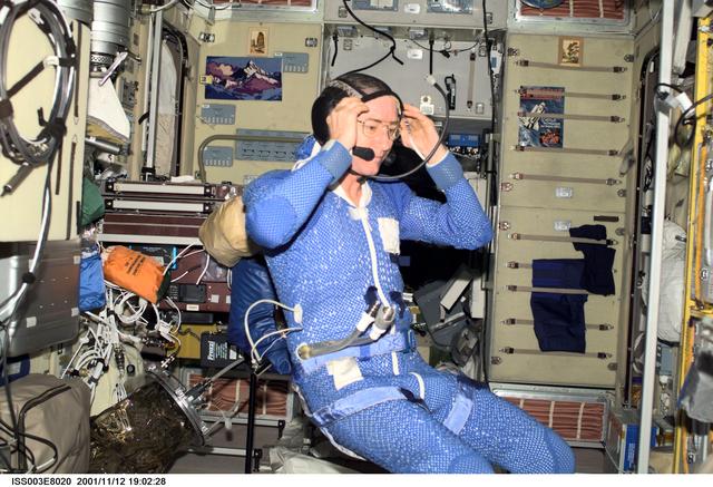 NASA image: Culbertson dons his communication headset before the third EVA of Expedition Three