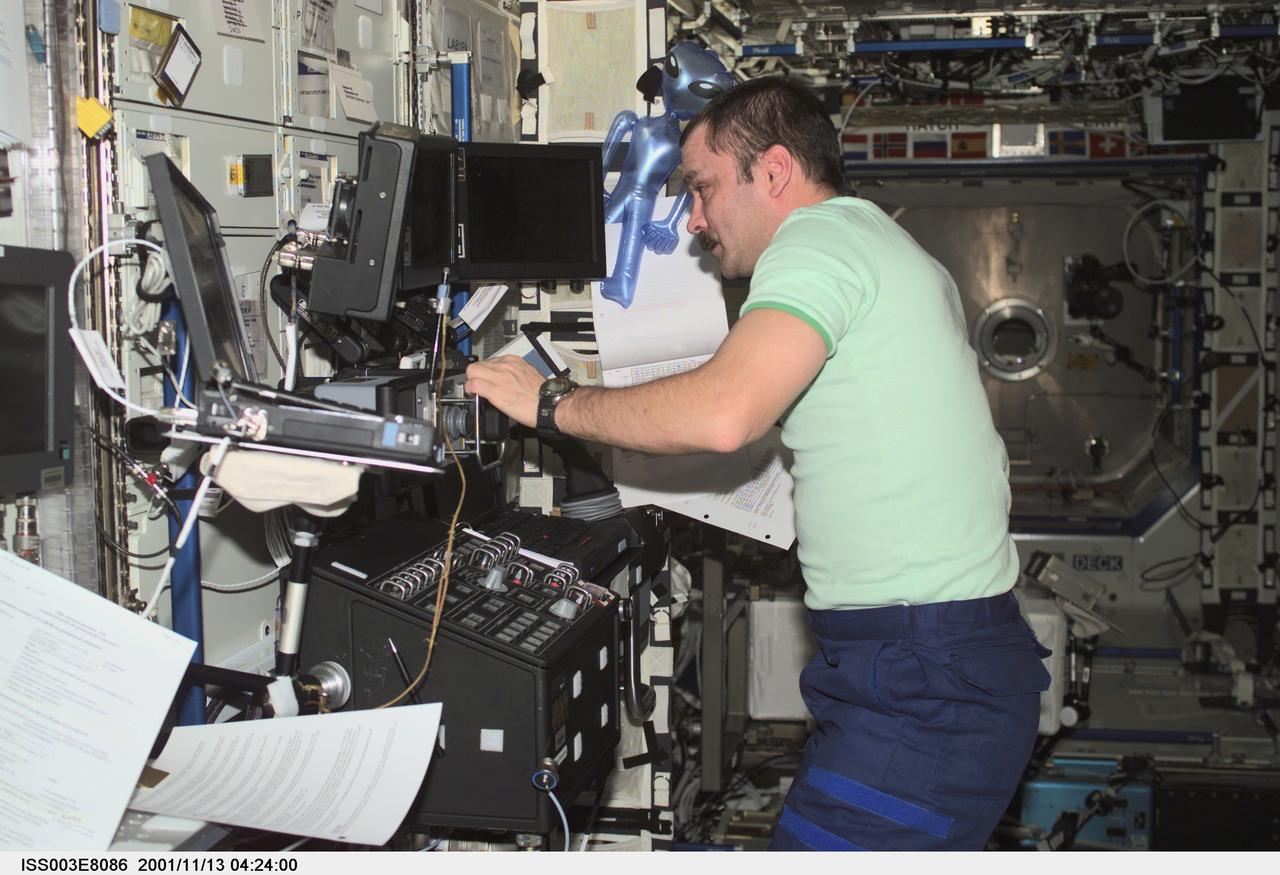 ISS003-E-8086 (13 November 2001) --- Cosmonaut Mikhail Tyurin, Expedition Three flight engineer representing Rosaviakosmos, works the controls of the Canadarm2, or Space Station Remote Manipulator System (SSRMS) in the Destiny laboratory on the International Space Station (ISS). This image was taken with a digital still camera.