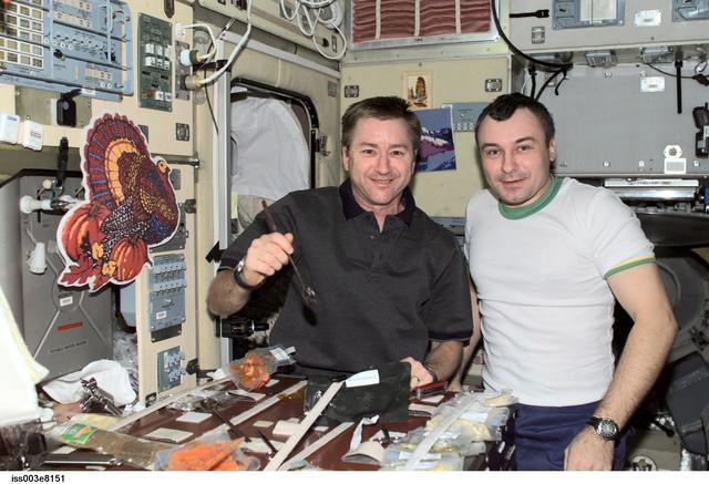NASA image: Dezhurov and Culbertson eat a Thanksgiving meal in Zvezda during Expedition Three
