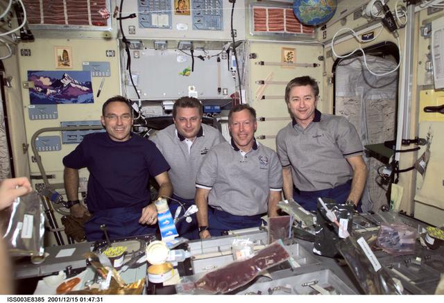 NASA image: Expedition Three, Expedition Four and STS-108 crews eat a meal in Zvezda