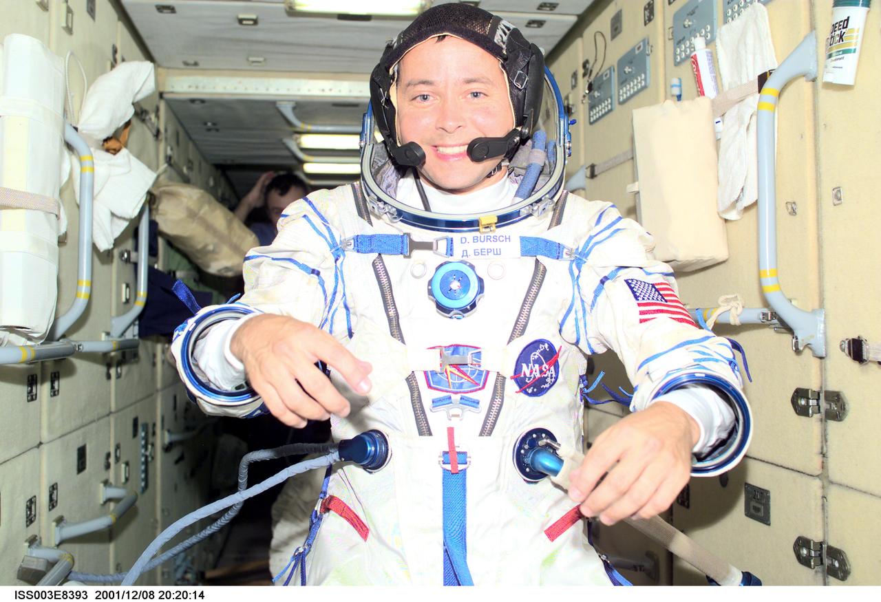 ISS003-E-8393 (8 December 2001) --- Astronaut Daniel W. Bursch, Expedition Four flight engineer, wearing a Russian Sokol suit, is photographed in the functional cargo block (FGB), or Zarya on the International Space Station (ISS). The image was taken with a digital still camera.