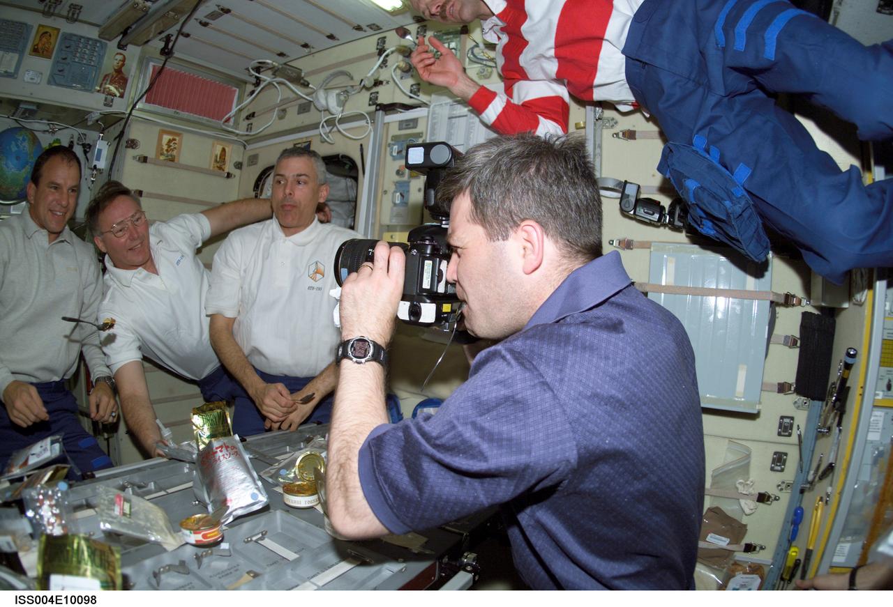 ISS004-E-10098 (16 April 2002) --- Astronaut Stephen N. Frick, STS-110 pilot, photographs crewmates in the Zvezda Service Module on the International Space Station (ISS). From the left are astronauts Michael J. Bloomfield, STS-110 mission commander, Jerry L. Ross and Lee M. E. Morin, both mission specialists. Astronaut Steven L. Smith, STS-110 mission specialist, floats above.
