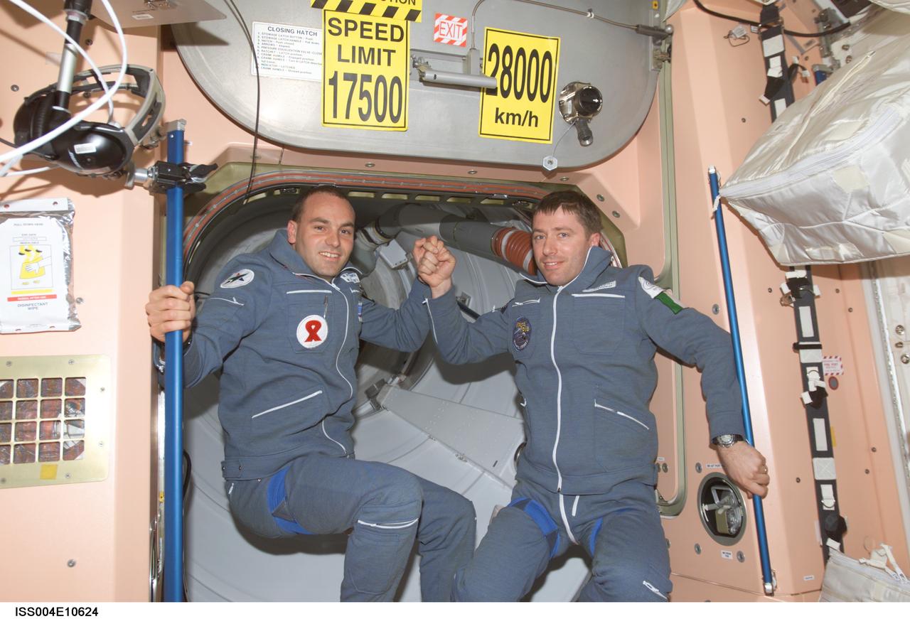 ISS004-E-10624 (27 April 2002) --- Two Soyuz Taxi crewmembers, South African space flight participant Mark Shuttleworth (left) and Flight Engineer Roberto Vittori of the European Space Agency (ESA), are photographed in the Unity node on the International Space Station (ISS). Soyuz Taxi Commander Yuri Gidzenko, representing Rosaviakosmos, is out of frame. The &#0147;taxi&#0148; crew arrived at the orbital outpost on April 27, 2002 at 2:56 a.m. (CDT) as the two vehicles flew over Central Asia.