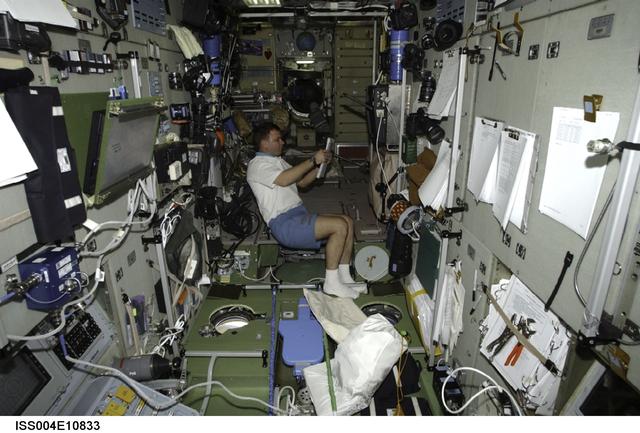 NASA image: Soyuz 4 CDR Gidzenko reads a checklist in Zvezda SM during Expedition Four