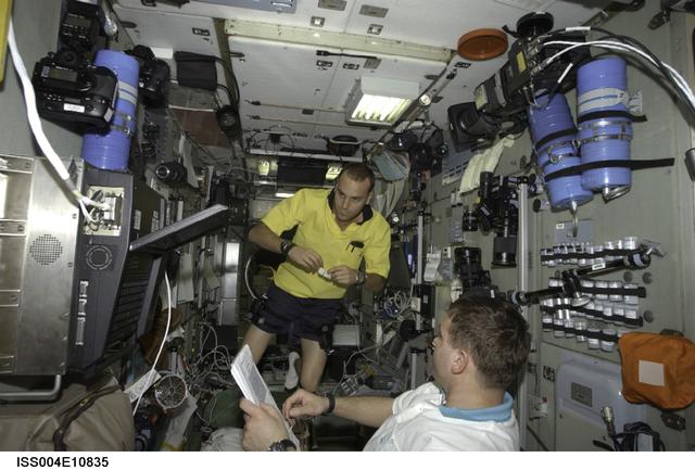 NASA image: Soyuz 4 CDR Gidzenko reads a checklist in Zvezda SM during Expedition Four