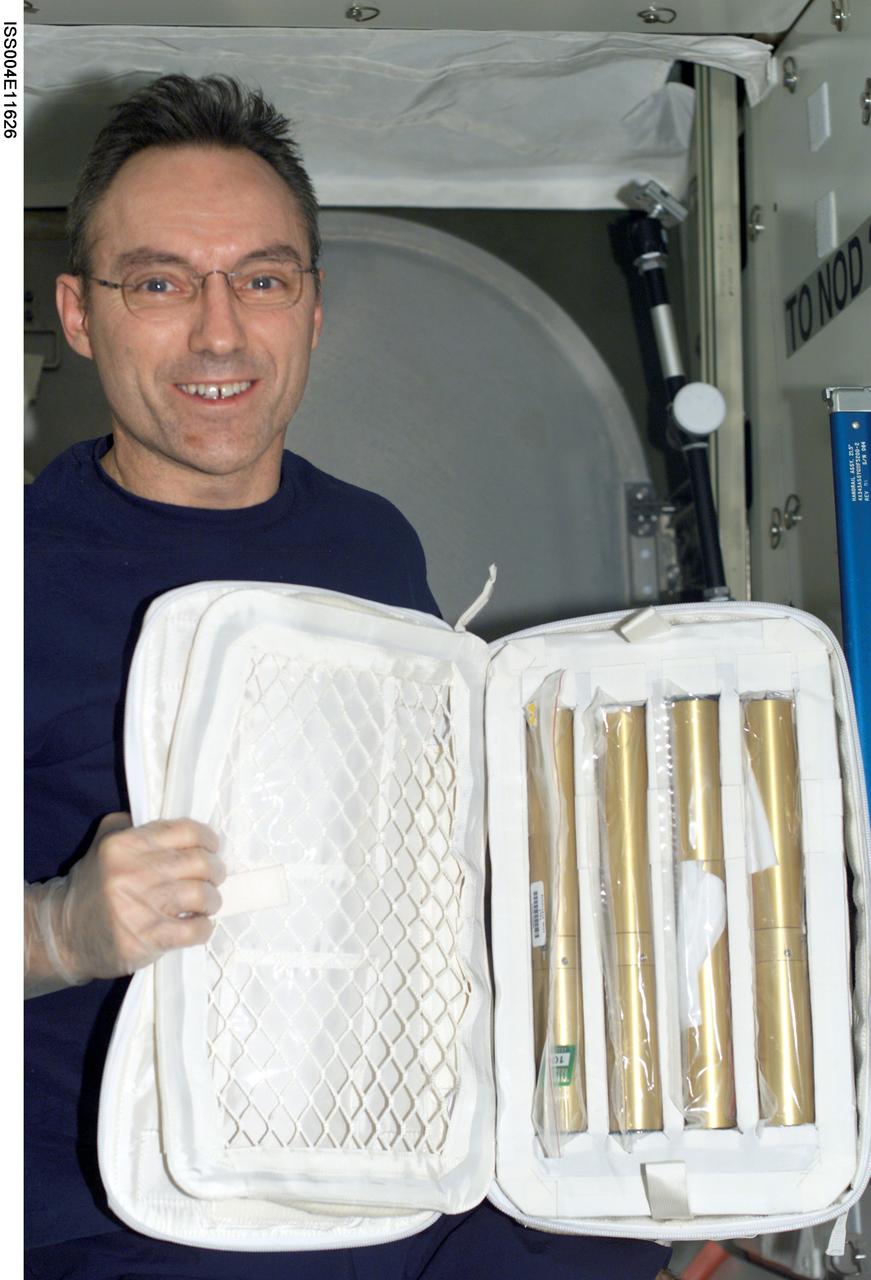ISS004-E-11626 (10 May 2002) --- Astronaut Carl E. Walz, Expedition Four flight engineer, holds a stowage bag containing autoclave units in the Destiny laboratory on the International Space Station (ISS).