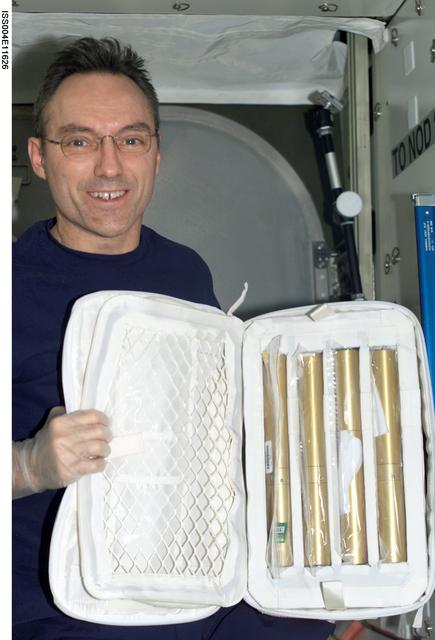 NASA image: Walz holds Autoclaves for the ZCG in the U.S. Lab during Expedition Four