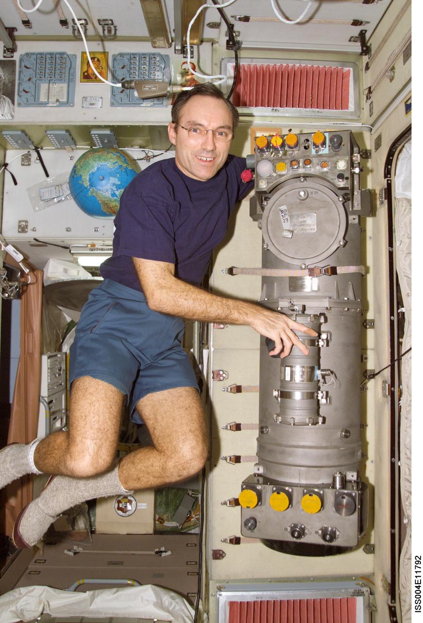 ISS004-E-11792 (26 April 2002) --- Astronaut Carl E. Walz, Expedition Four flight engineer, works on the Elektron Oxygen Generator in the Zvezda Service Module on the International Space Station (ISS).