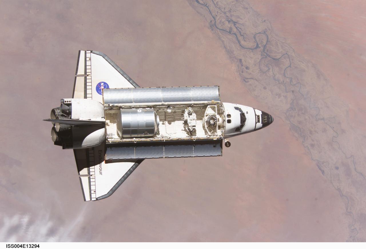 ISS004-E-13294 (7 June 2002) --- The Space Shuttle Endeavour approaches the International Space Station (ISS) in this digital still camera's view, recorded on June 7, 2002. The Multi-Purpose Logistics Module (MPLM), known as Leonardo, is visible in Endeavour's payload bay. Two Russian cosmonauts and an American astronaut, currently onboard the shuttle, will replace two American astronauts and a Russian cosmonaut now on the station.