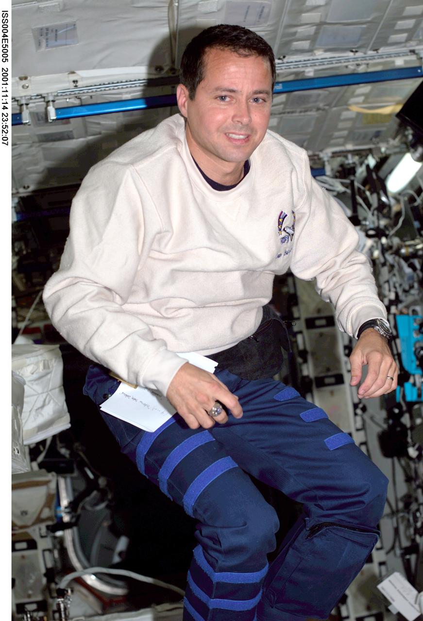 ISS004-E-5005 (December 2001) --- Astronaut Daniel W. Bursch, Expedition Four flight engineer, floats in the Destiny laboratory on the International Space Station (ISS). The image was taken with a digital still camera.